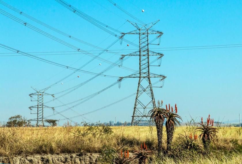 Close up of electric pylons and power lines against clear blue sky in South Africa.jpg